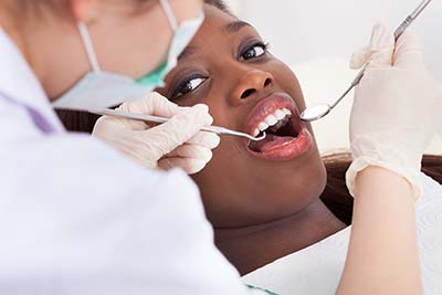 woman getting her teeth cleaned in Dallas, GA